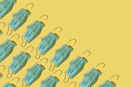 Medical masks pattern on a yellow backgroundの写真素材