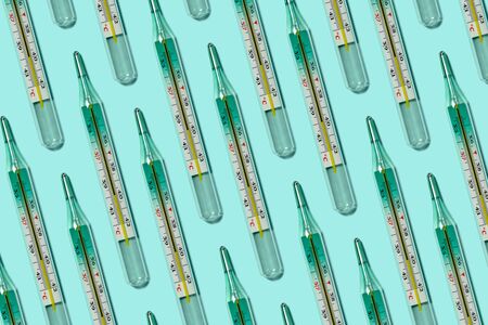Medical mercury thermometers pattern close-up on blueの写真素材