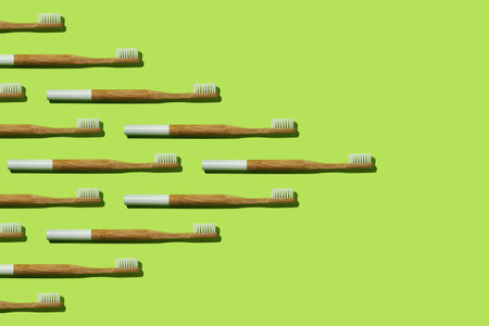 Pattern: bamboo toothbrushes wedge-shaped on green background