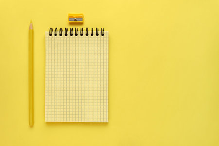 Notepad and yellow pencil are on the left side of the screen