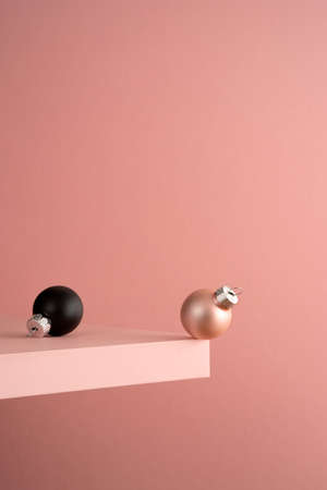 Black and pink christmas balls on the shelf at the edge of the cliffの写真素材