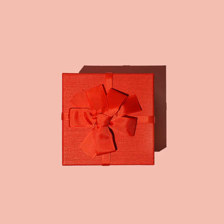 Red gift box on pink background view from above. Flat lay.の写真素材