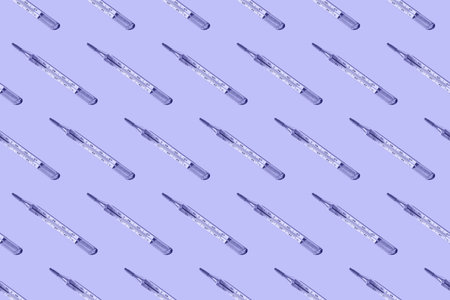 Medical mercury thermometers pattern on very peri background.