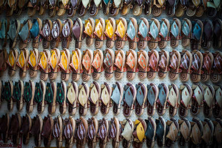 Colorful slippers hanging on the wall of a shop in Indiaの写真素材