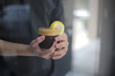 Hand holding a cup of coffee.の写真素材