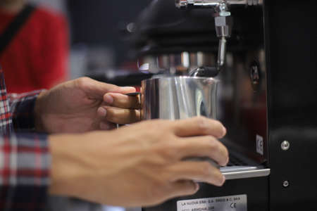 Hands are holding the coffee jar.の写真素材