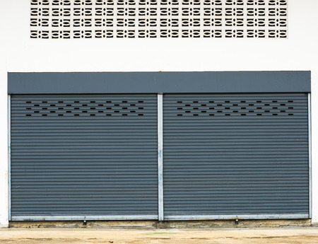 Steel rolling shutter on the white wall.の写真素材