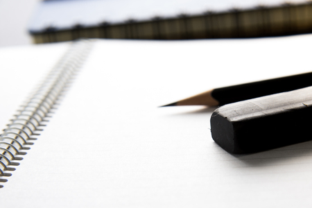 black eraser on blank notebook with a pencilの写真素材