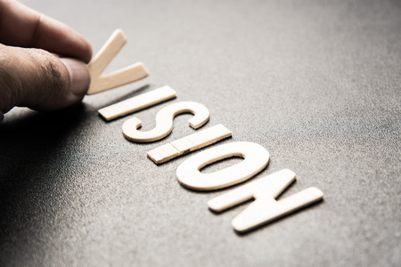 wooden letter of word  VISION on black backgroundの写真素材
