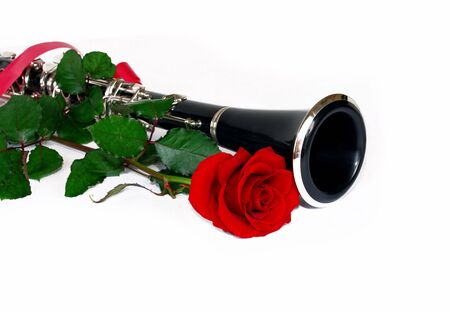 beautiful red rose and clarinet composition over whiteの写真素材