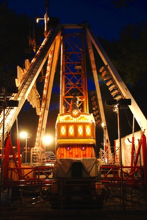 illuminated Construction of carousel in evening park illuminated Construction of carousel in evening park
