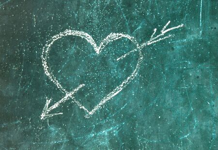 Love symbol on old green blackboardの写真素材