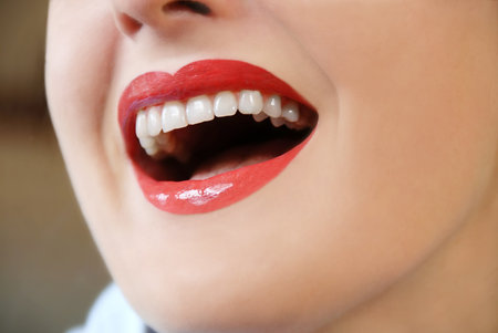 woman with white teeth and red lips laughing