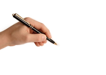 Left handed child writing nothing on white backgroundの写真素材