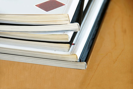 Black and white magazines  pile closeup on wooden desk