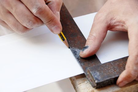 manual worker hands drawing a line  on white plastic trackの写真素材