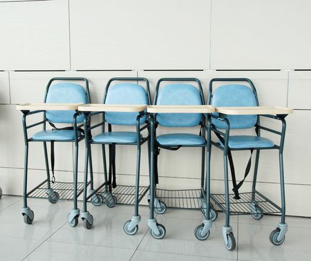 four baby blue sitting chairs in row indoorの写真素材