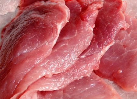 raw red pork meat slices closeup background