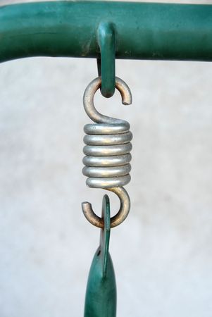metallic silver spring connecting two parts of swing closeupの写真素材
