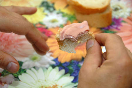 least piece of sandwich with ham in handsの写真素材