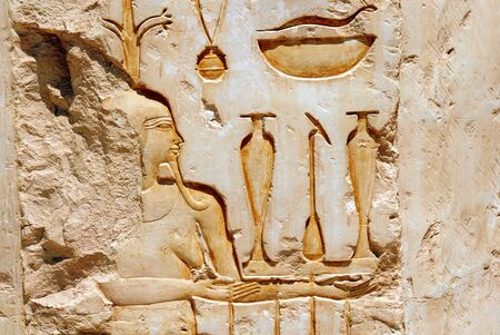 Egyptian  hieroglyphics on limestone wall in egyptian templeの写真素材