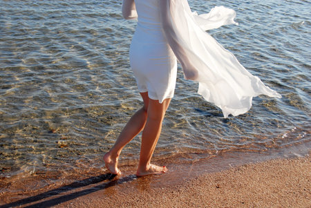 Walking by sea on sand
