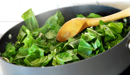 Preparing spinach, cutting green fresh leaves for cooking