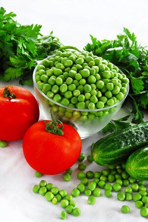 food ingredients, appetizing fresh vegetables, green peas, cucumber and red tomatoesの写真素材
