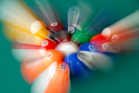 group of billiards balls moving in various directionsの写真素材