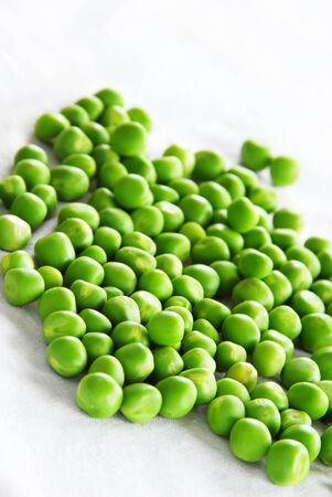 young fresh organic green spring peas scatteredの写真素材