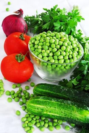 food ingredients, appetizing fresh vegetables, green peas, cucumber and red tomatoesの写真素材