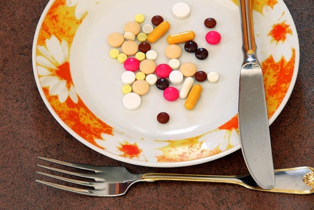 various colorful pills served on plate closeupの写真素材