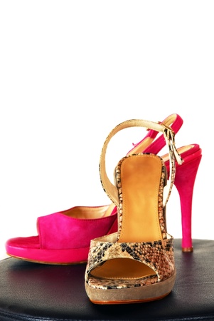pair of fashionable sexy snake designed high heeled shoes over whiteの写真素材