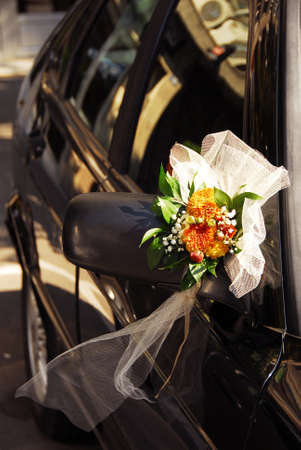 wedding flowers decoration on black car mirrorの写真素材