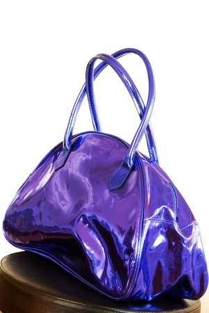 fashionable purple blue metallic color bag over whiteの写真素材