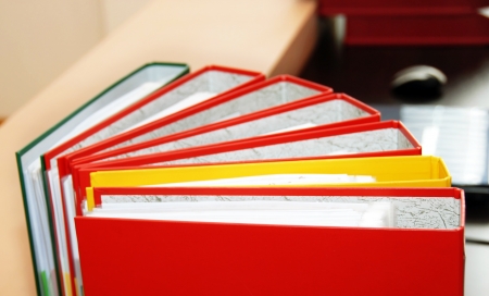 colorful files with documents  on office deskの写真素材
