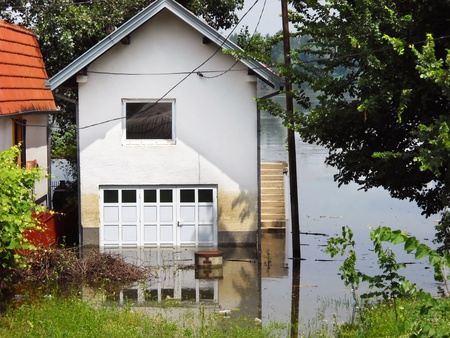 house surrounded by water in river during spring flood in Serbiaの写真素材
