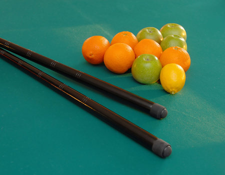 oranges and apples in triangle shape on green billiards table