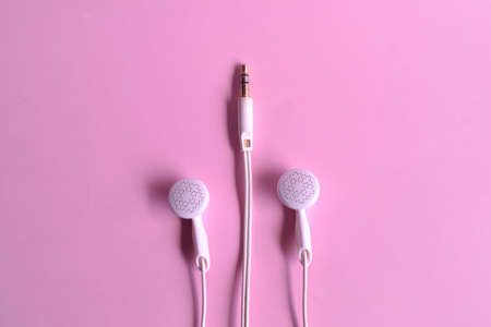Eraphones or earbuds on pink backgroundの写真素材