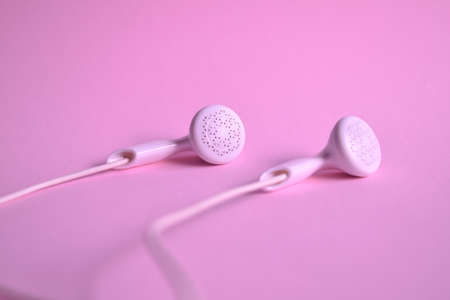 Earbuds or earphones on pink backgroundの写真素材