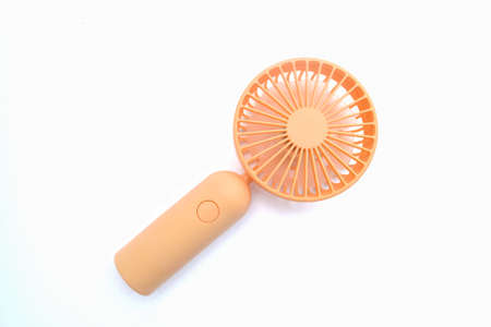 Close-up of orange portable fans. Portable rechargeable mini fans.の写真素材