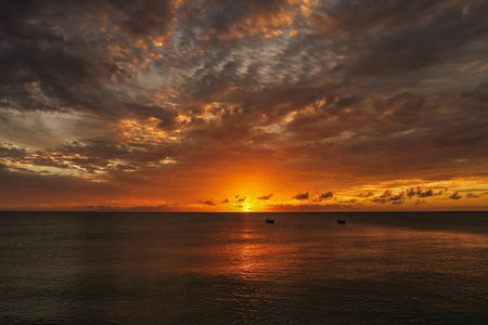 Orange sunset over the ocean at Caribbean islandsの写真素材