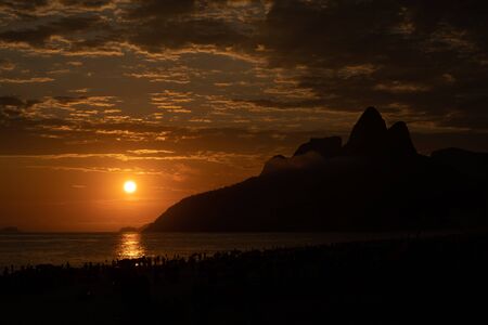 Silhouette of Dois Irmaos during an amazing sunset over Ipanema beach in Rio de Janeiroの写真素材