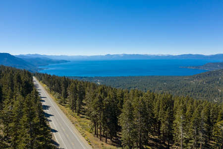 Aerial, drone view of Lake Tahoe in California surrounded by pine tree forestsの写真素材