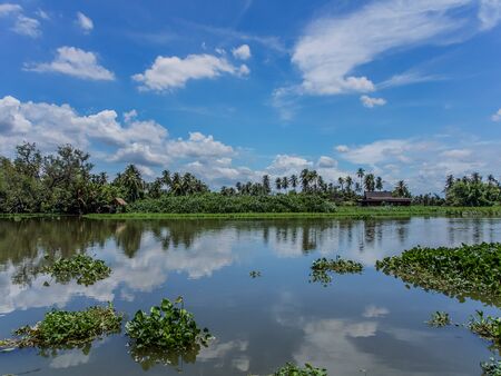 Typical Thai style house and small hut by the riverの写真素材