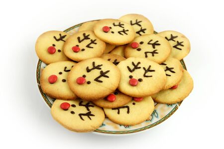 Christmas reindeer cookies on plate isolated on whiteの写真素材