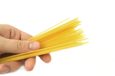 Man's hand holding a spaghettiの写真素材