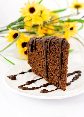 Gingerbread on plate. Yellow flowers in backgroundの写真素材
