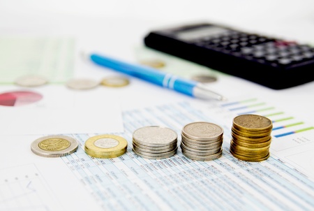 Coins stack on colorful business backgroundの写真素材