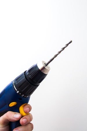 Hand holding blue drillの写真素材